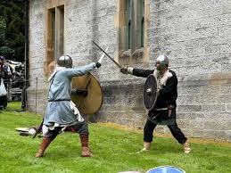 Two Viking warriors fighting with sword and shields